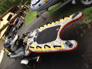 Jet ski with inflatable rescue sled that tracks with  the jet wake